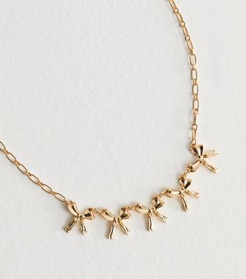 Gold Tone Bow Charm Necklace 3 Gold Tone Bow Charm Necklace